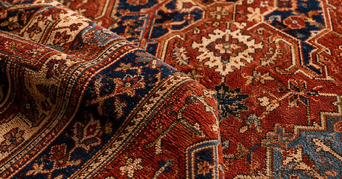 Antique Persian Heriz rug with a bold geometric medallion and corner spandrels on a terracotta field